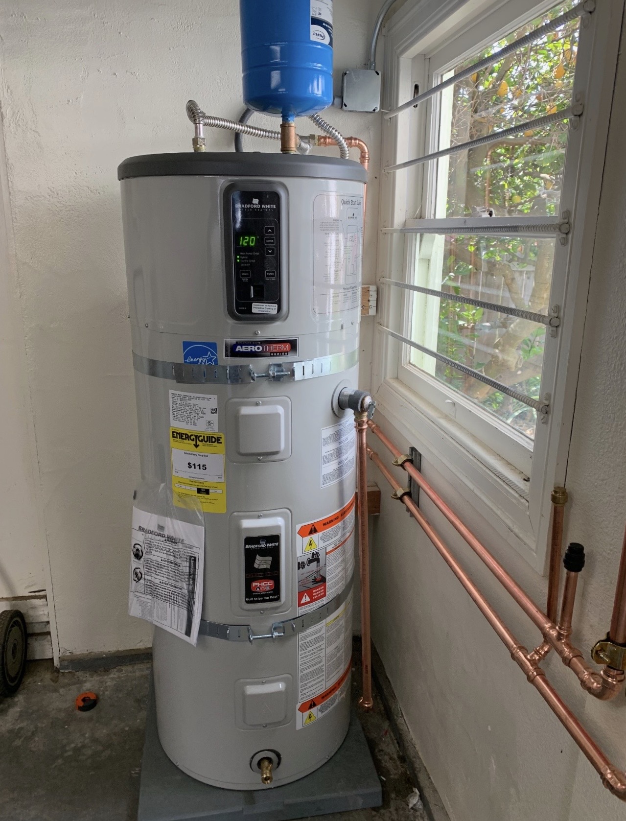Professional tank water heater installation with copper piping
